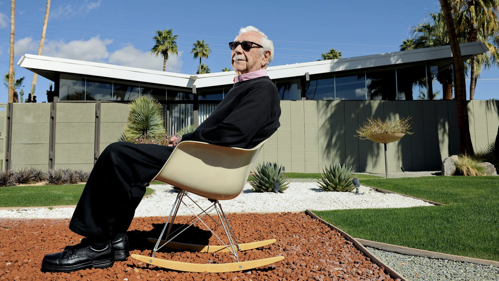 William Krisel in front of a home in Twin Palms.